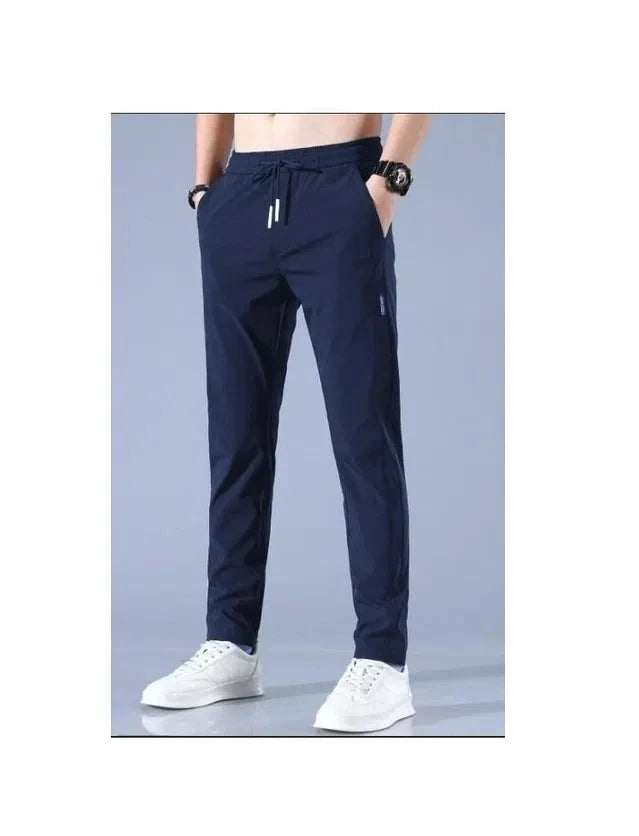 Navy blue lycra track pants for men with drawstring waist and tapered fit