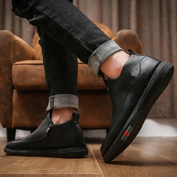 Mens casual black shoes for work with side zipper and comfortable sole paired with rolled-up black jeans