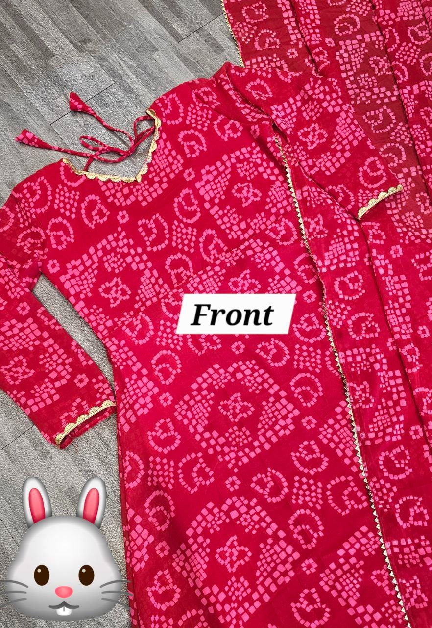 Front view of red bandhani gown for women laid flat with long sleeves gold border and ties