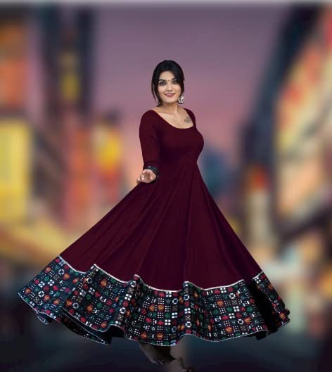 Woman in maroon twirling full skirted gown with colorful hem border solid pattern stitched gown for women
