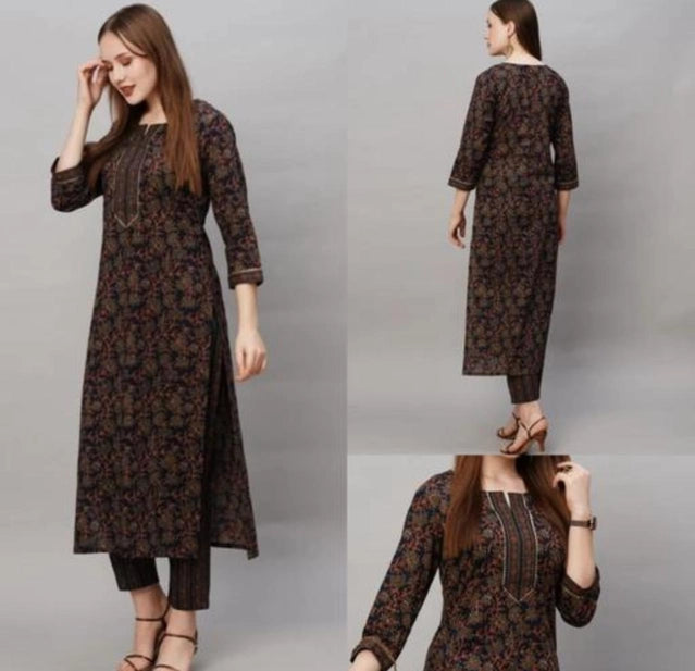 Woman wearing dark floral long kurta with three quarter sleeves paired with cropped pant cotton blend kurti with pant