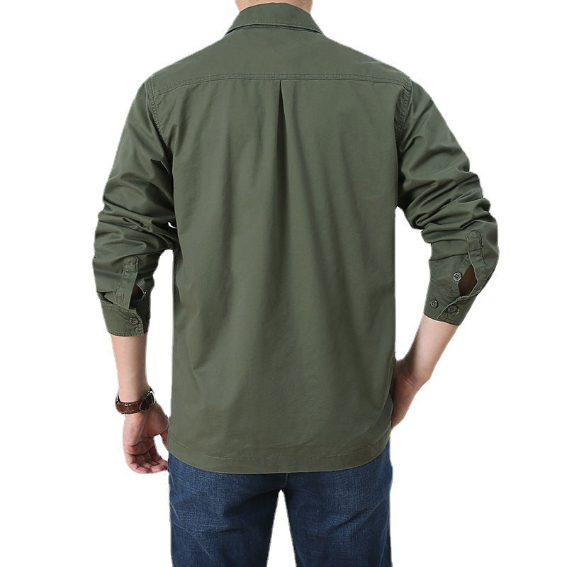 Back view of olive green mens lightweight button up shirt with long sleeves rolled over jeans on model