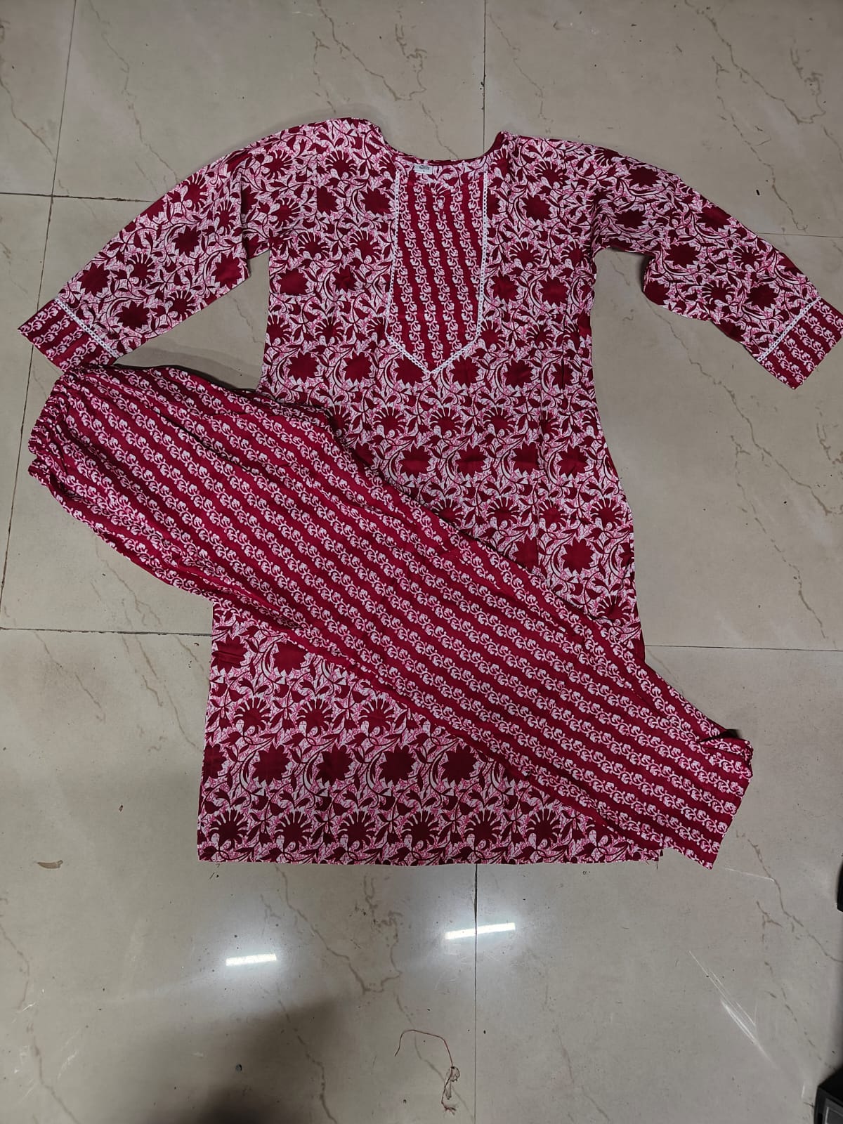 Red and white printed floral cotton kurta set for women flat lay with long kurta and matching straight pants