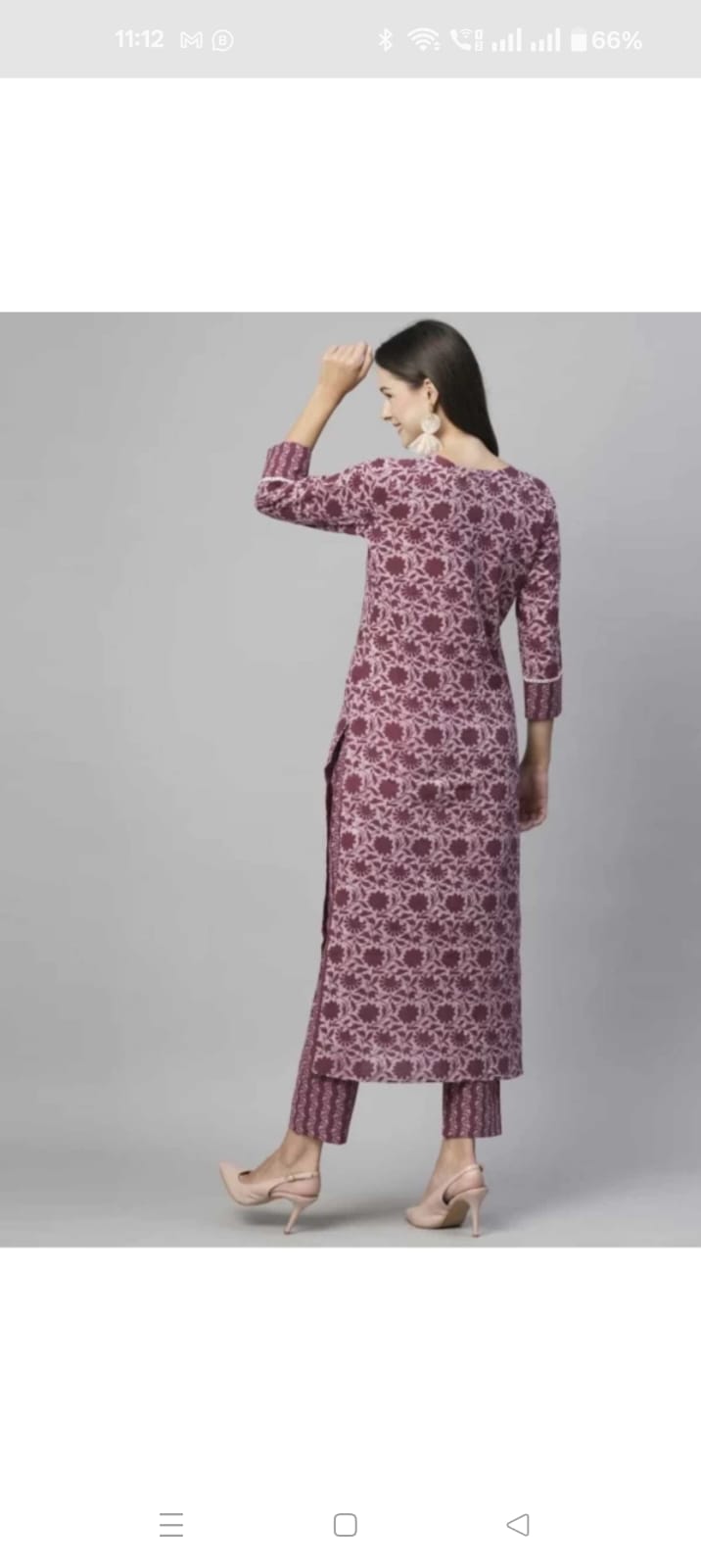 Back view of woman wearing purple printed floral cotton kurta set for women with three quarter sleeves and matching straight pants