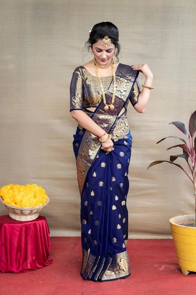 Banarasi silk saree royal blue worn by woman with gold zari motifs matching blouse and traditional jewelry