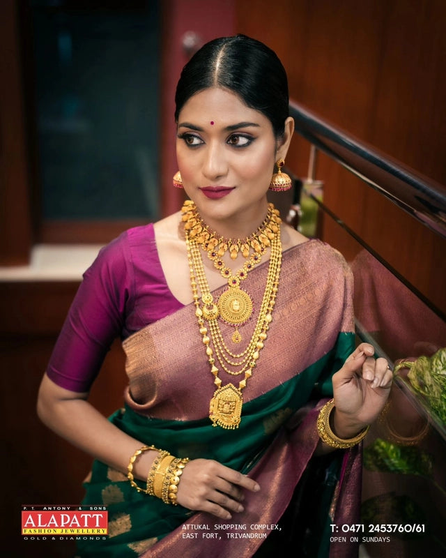 Banarasi silk saree for women green and pink saree with layered gold jewelry and traditional styling
