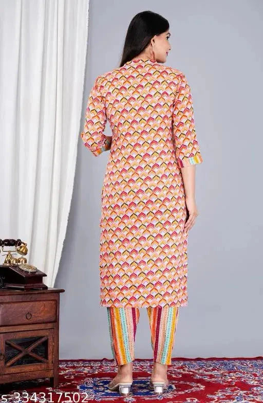 Back view of a woman wearing stylish Indian kurta sets with colorful printed kurti and striped leggings