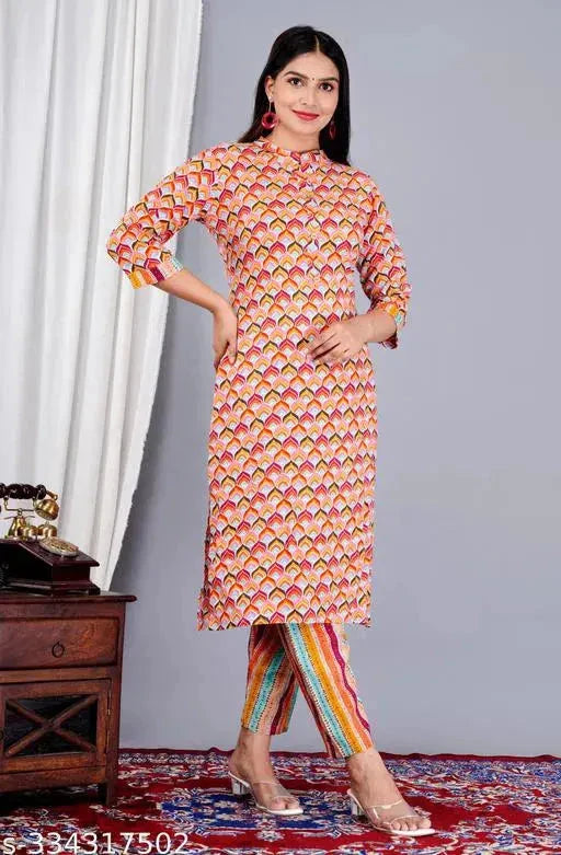 Woman wearing stylish Indian kurta sets with colorful geometric print kurti and striped pants