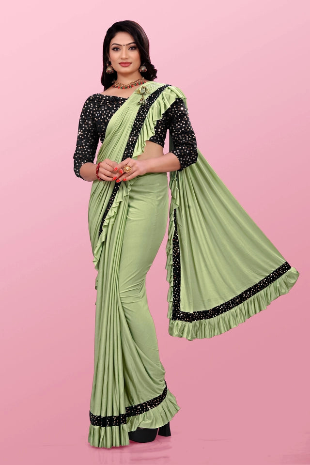 Affordable party wear saree for women in light green with black and white polka dot blouse and border design