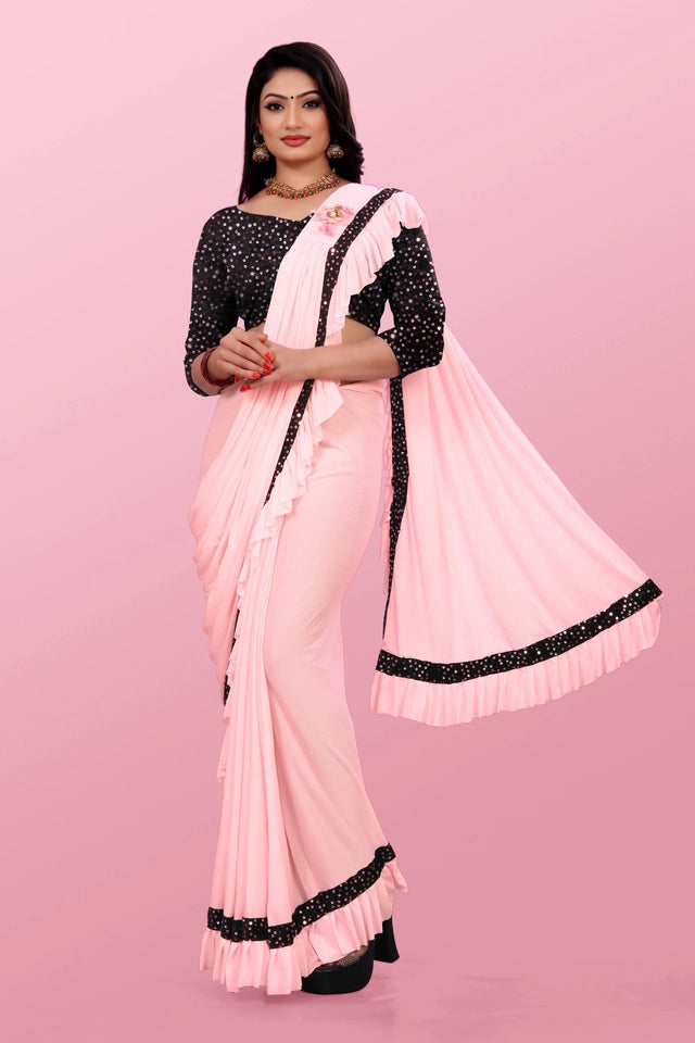 Affordable party wear saree for women in light pink with black polka dot blouse and ruffle border