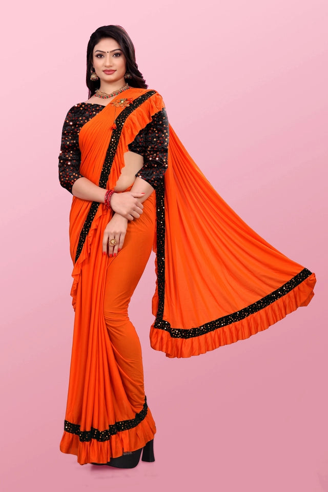 Woman wearing an orange affordable party wear saree for women with black embellished border and blouse