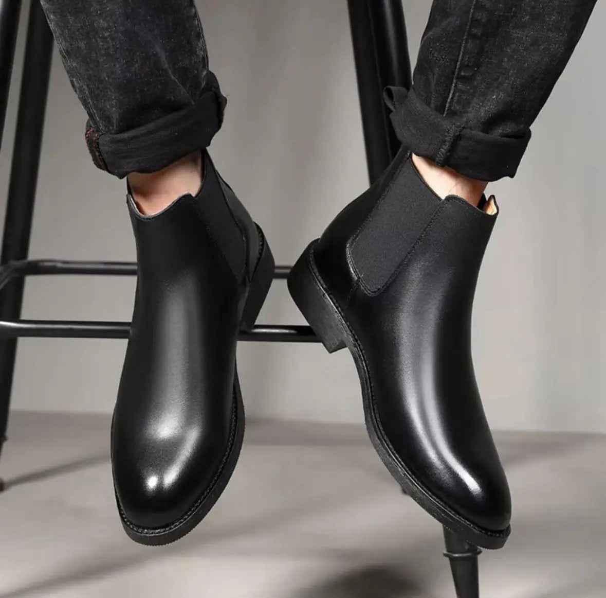Black slip on boots for men with sleek design and elastic side panels for easy wear