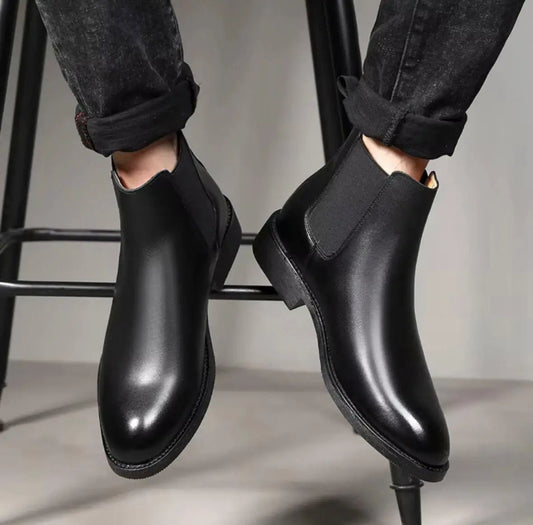 Black slip on boots for men with sleek design and elastic side panels for easy wear
