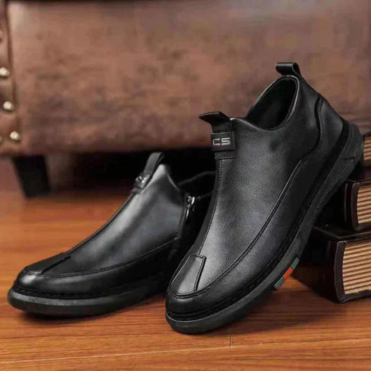 Mens casual black shoes for work with slip-on design and comfortable sole on wooden floor