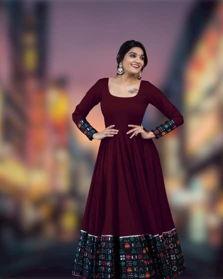 Maroon ankle length dress with patterned hem and cuffs worn by smiling model solid pattern stitched gown for women