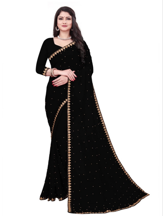 Model wearing a black designer saree for women with gold embroidered border and scattered stone embellishments
