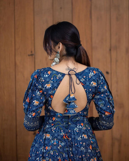 Back view of woman wearing blue printed georgette gown for women with keyhole back ties and tassel detailing