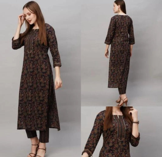 Woman wearing dark floral long kurta with three quarter sleeves paired with cropped pant cotton blend kurti with pant