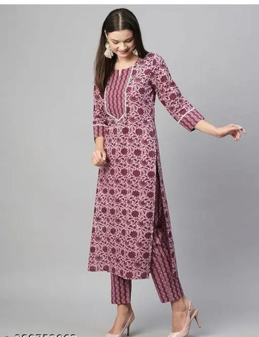 Model wearing mauve printed floral cotton kurta set for women with straight pants and side slits