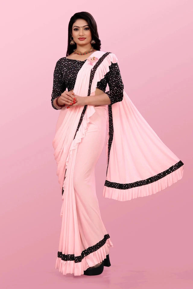 Affordable party wear saree for women in light pink with black polka dot blouse and ruffle border