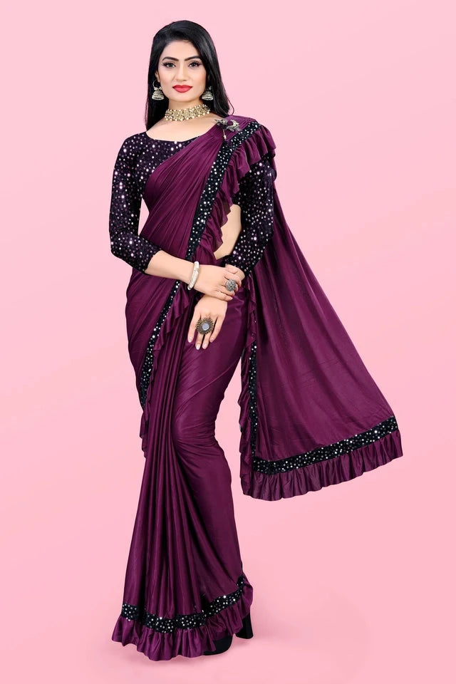 Woman wearing an affordable party wear saree for women in deep purple with black sequin blouse
