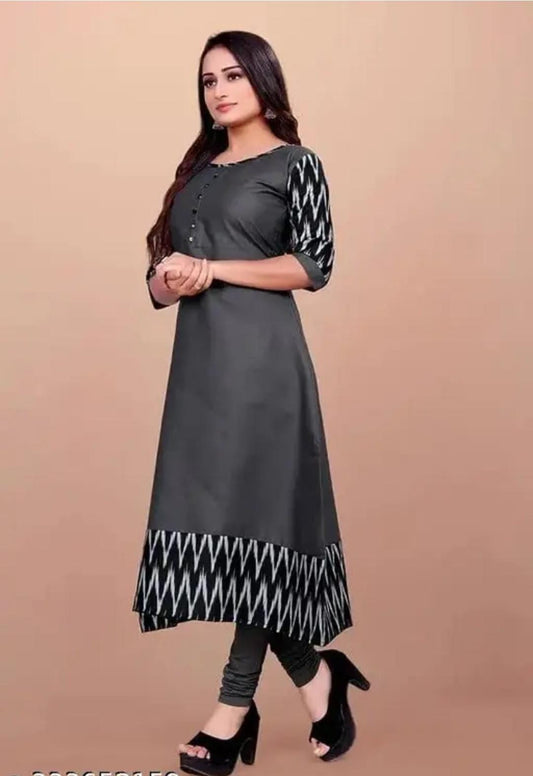 Model wearing grey cotton gown for women with patterned three quarter sleeves and geometric hemline