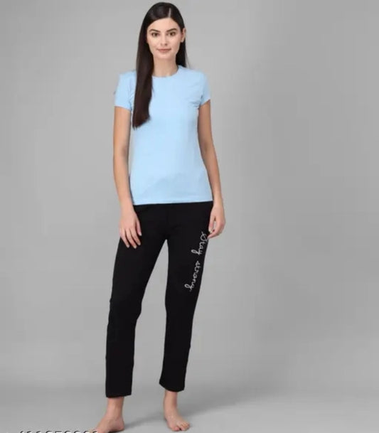 Model wearing black cotton blend trousers for women with slim straight leg and white side script paired with light blue tee